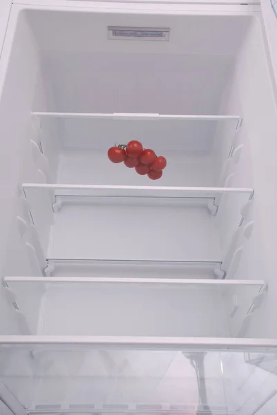 Pomodori ciliegia in frigorifero vuoto aperto . — Foto Stock