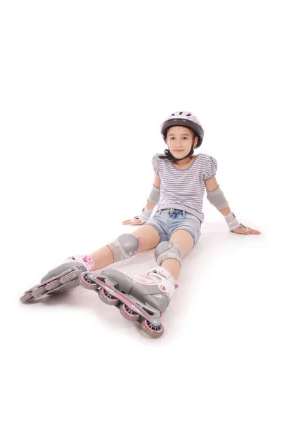 Happy little girl with roller skates and protective gear resting. — Stock Photo, Image