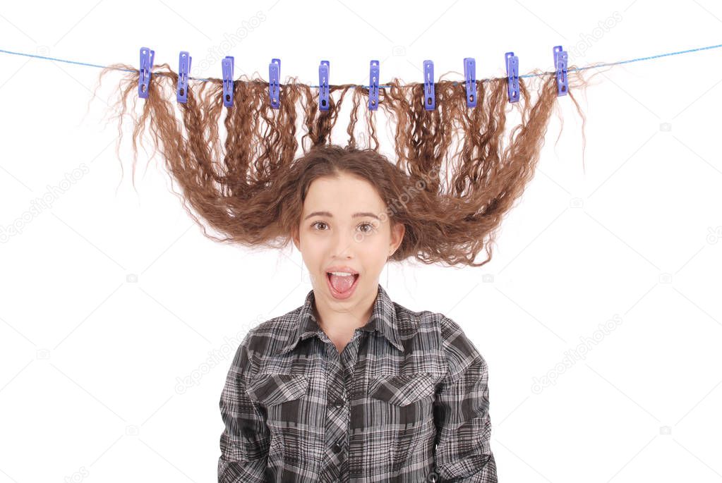 Girl drying her hair on a rope.
