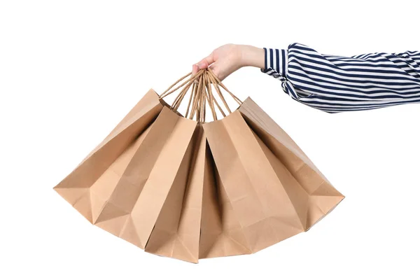 Niño mano sosteniendo bolsas de papel aisladas en blanco —  Fotos de Stock