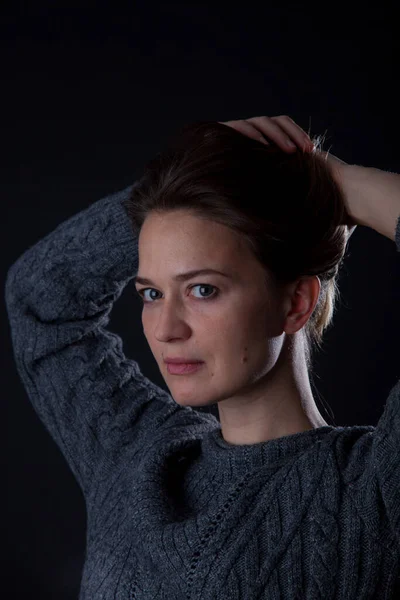 Woman on black background looking at camera. front