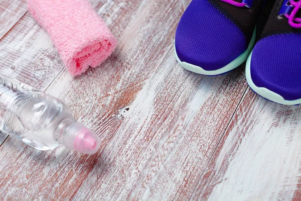 sport shoes and water on a wooden background