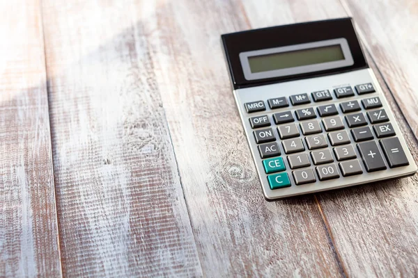 Calculator on a wooden background — Stock Photo, Image