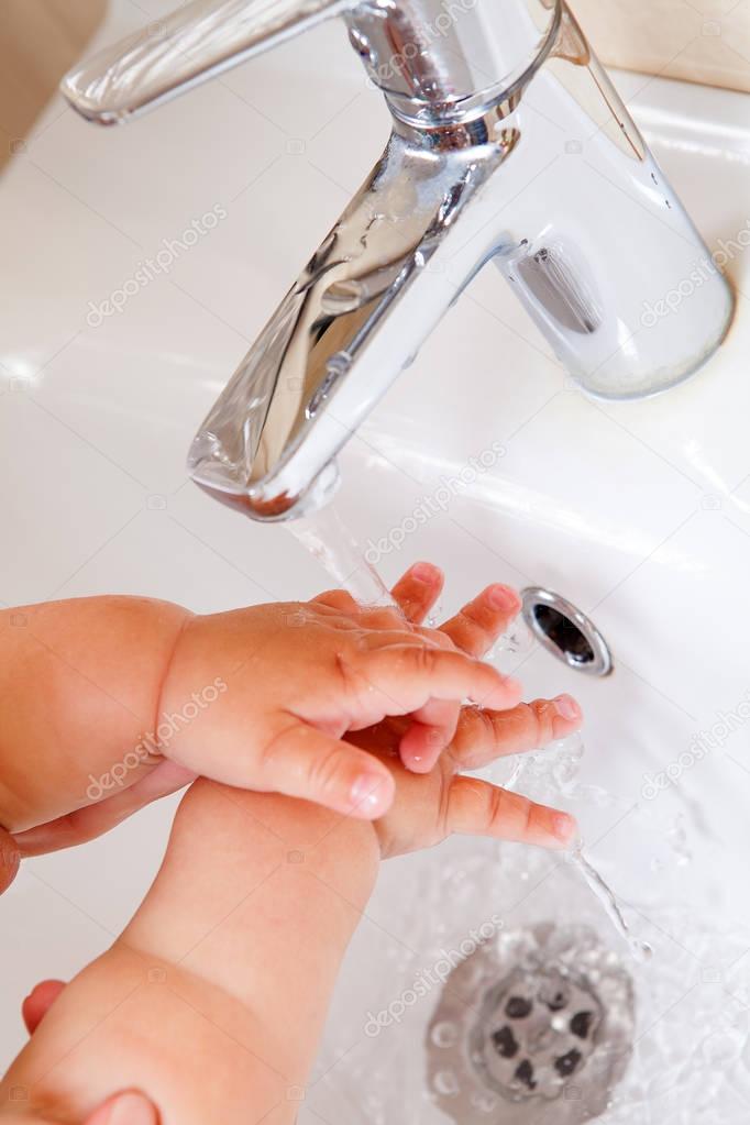 Child 's hands under water