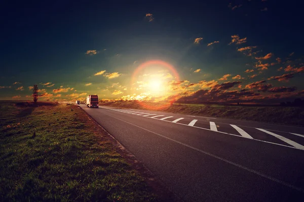 Truck on a highway at sunset. — Stock Photo, Image