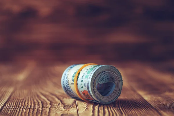 Dollars on a wooden background — Stock Photo, Image