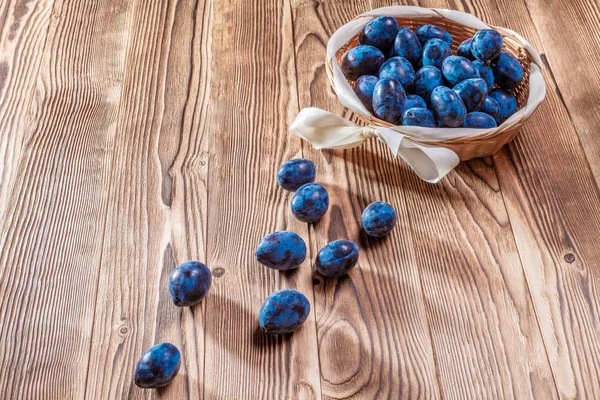 blue plums  on a wooden background