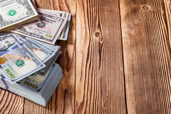 Δολάρια σε φόντο ξύλινη — Φωτογραφία Αρχείου