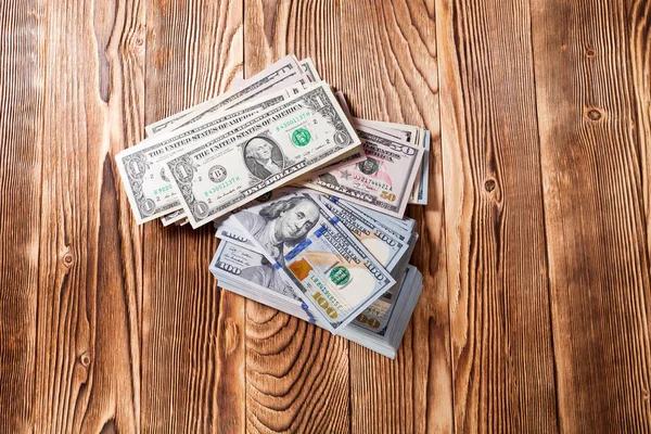 Dollari su uno sfondo di legno — Foto Stock