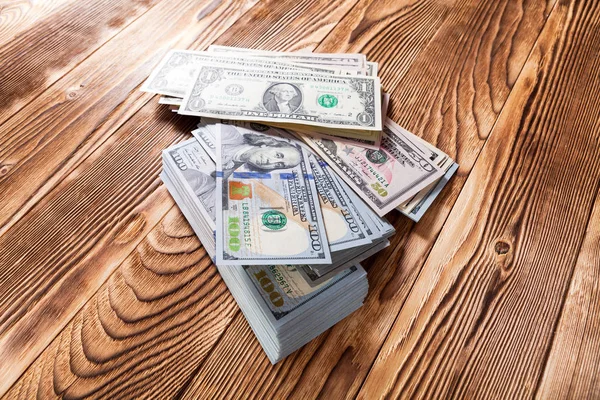 Dólares sobre un fondo de madera — Foto de Stock