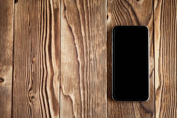 Smartphone en mesa de madera — Foto de Stock