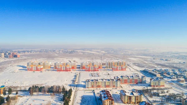 Aerial, winter town  by small river.