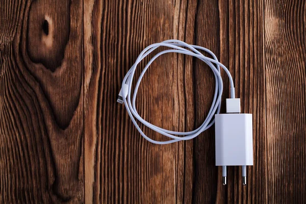 Cable phone chargers on wood background