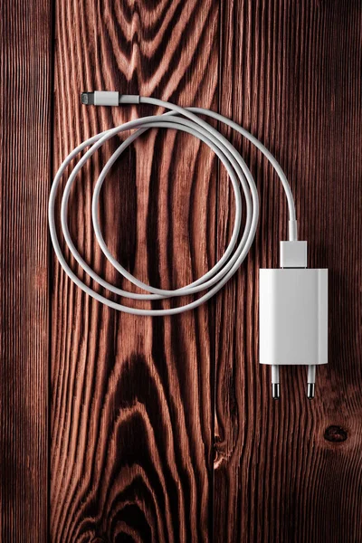 Cable phone chargers on wood background