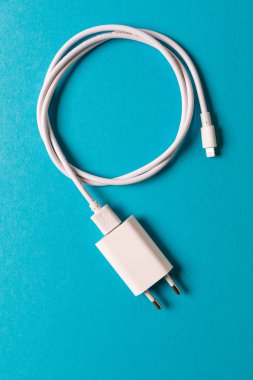 Cable phone chargers on blue background clipart