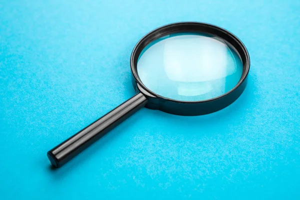Magnifying glass. Search tool. blue background