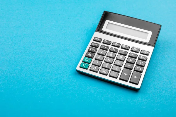 Calculator on a blue background. — Stock Photo, Image