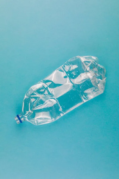 Sticle de plastic zdrobite pe un fundal albastru. Gunoi din plastic . — Fotografie, imagine de stoc