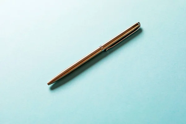 metal pen isolated on blue background