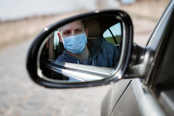 Man in the medical mask in car. coronavirus, disease, infection, quarantine, covid-19