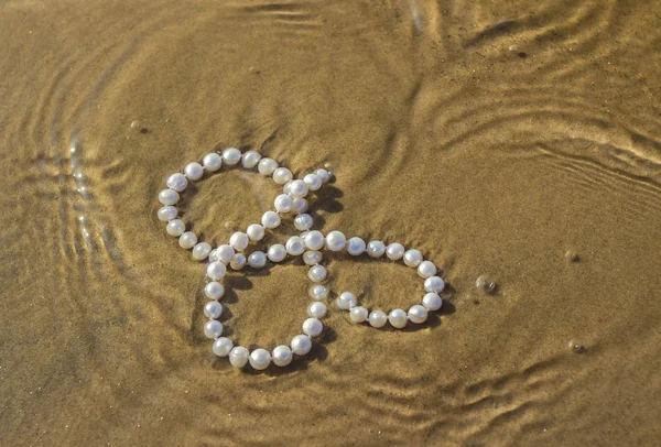 Pérolas na areia do mar — Fotografia de Stock