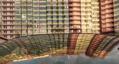 Arabanın camına yansıyan çok katlı bir bina.