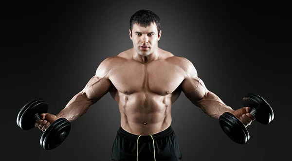 Portrait of bodybuilder with dumbbells — Stock Photo, Image