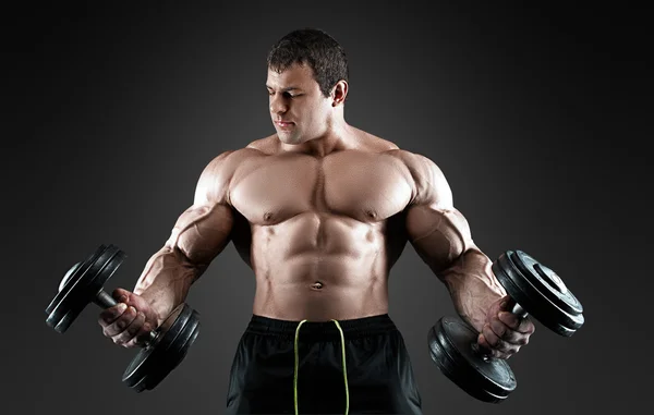 Portrait of bodybuilder with dumbbells — Stock Photo, Image