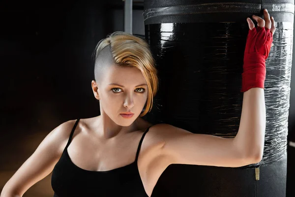 Cool fit woman and punching bag. — Stock Photo, Image