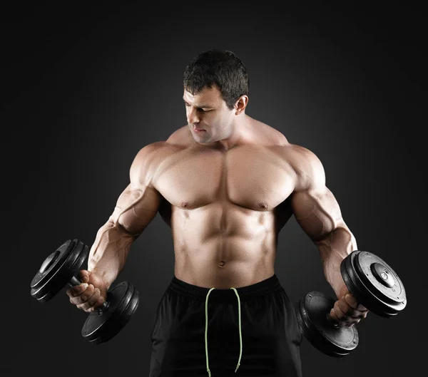 Portrait of bodybuilder with dumbbells — Stock Photo, Image