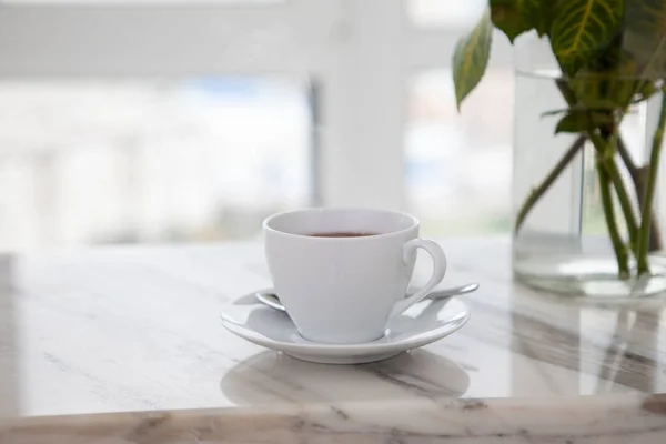 Cup of coffee on marble table — Stock Photo, Image