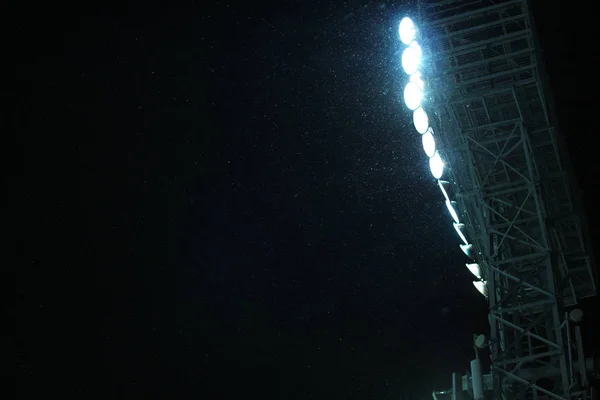 Stadion Spot światło wieży podczas opadów śniegu tle niebo ciemna noc — Zdjęcie stockowe