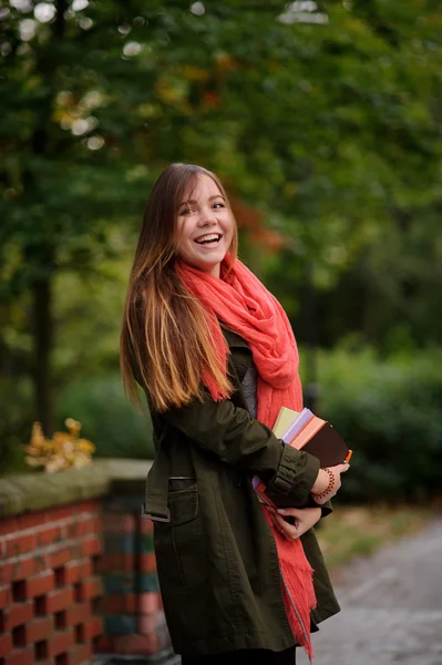 Charming student in a beautiful autumn park. — Stock Photo, Image