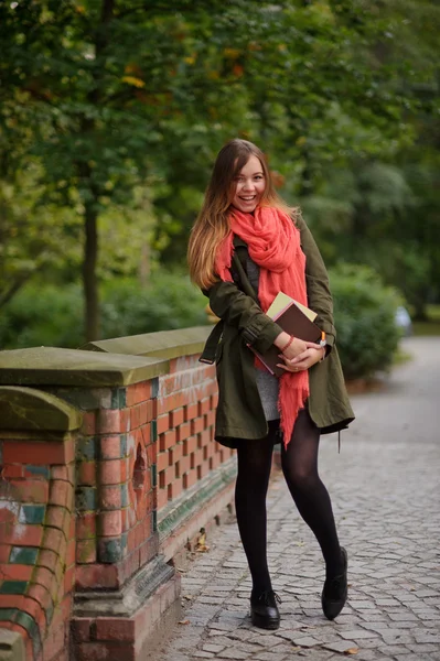 Young student standing on the bridge in the Park. — Stock Photo, Image