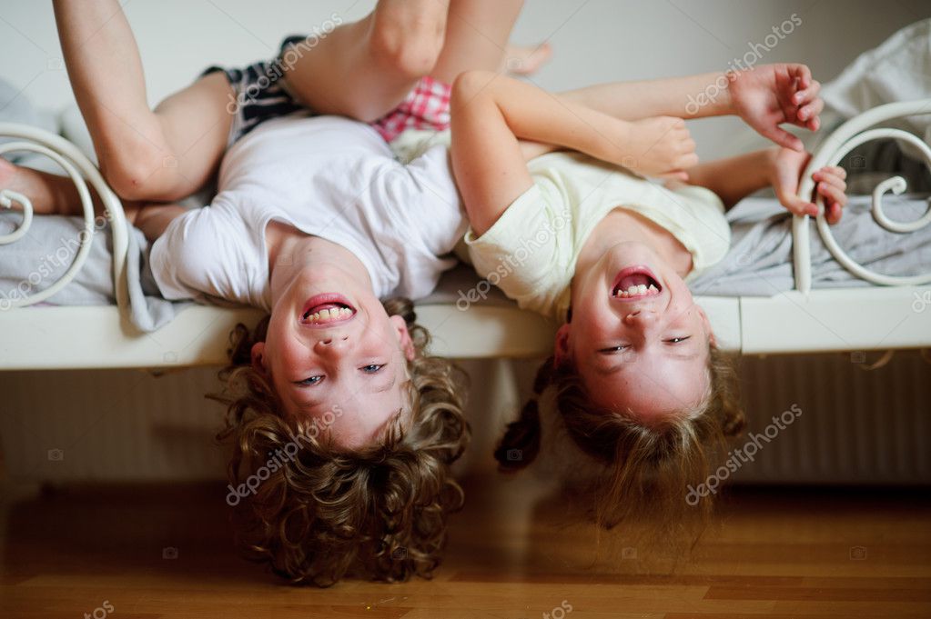 The Children Boy And Girl Naughty On The Bed In The