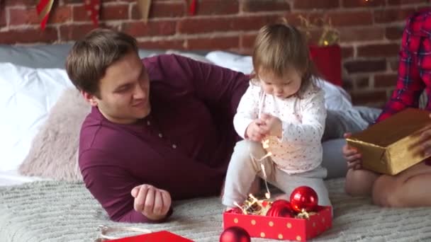 Young family gleefully congratulates each other Marry Christmas. — Stock Video