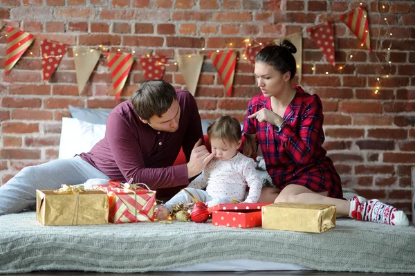 Ibu, ayah dan putri kecil bersukacita untuk hadiah Natal . — Stok Foto