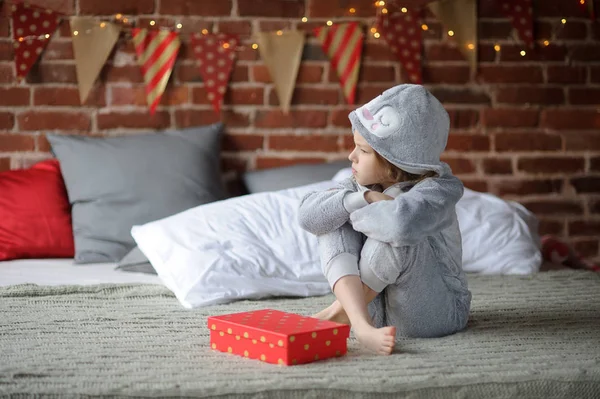 Little girl is disappointed with a gift.