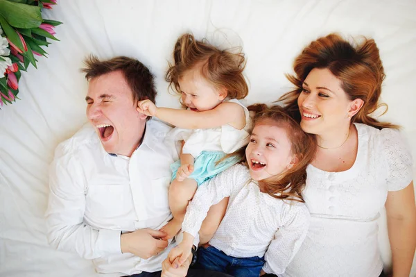 Gran familia unida de cuatro personas pasa alegremente el tiempo para las camas — Foto de Stock