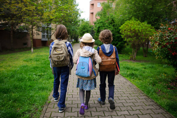 Little school students hurry on occupations.