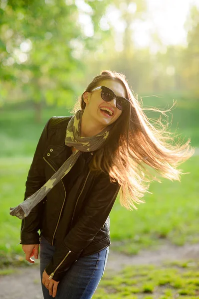 Portrait of the young cheerful woman in beams of the sun. — Stock Photo, Image