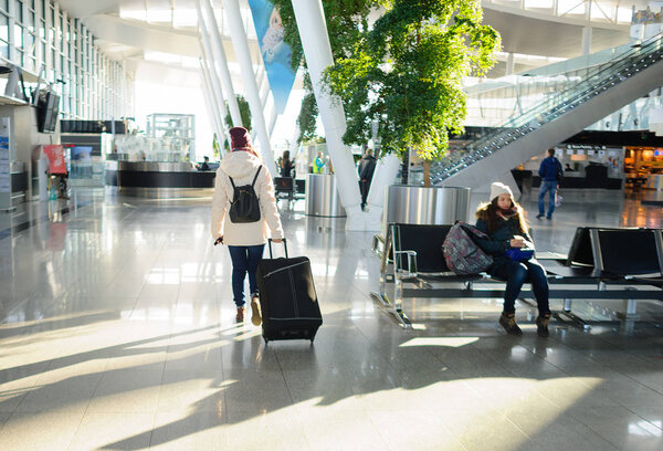 Passengers in the airport waiting room.