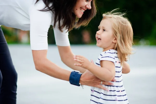 Jonge vrouw duurt het dochtertje op handen — Stockfoto