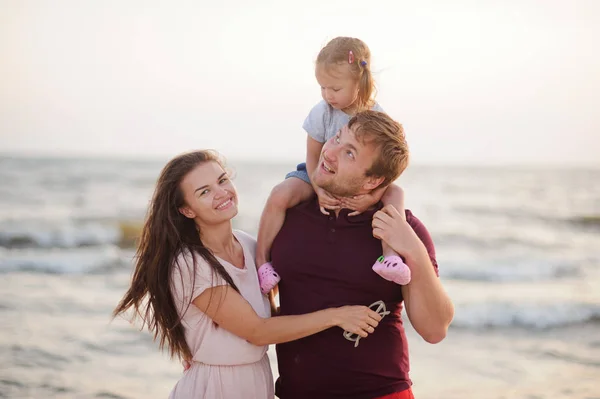 Jovem família feliz contra o mar . — Fotografia de Stock