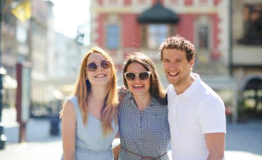 Üç genç insanlar antik kent meydanında stand.