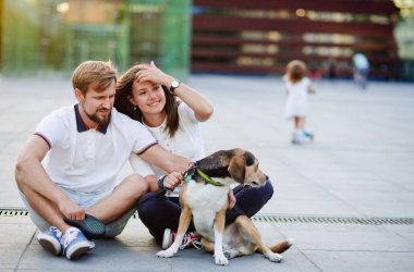 Sevimli genç çift yakından birbirine yuvalanmış dünya üzerinde oturur.