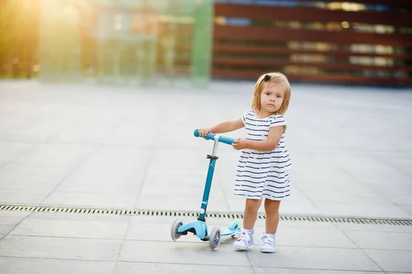 Портрет двухлетней девочки со скутером . — стоковое фото