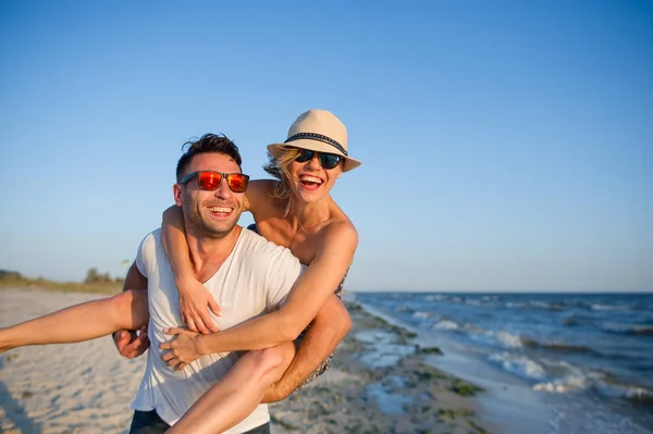 Jonge man houdt op handen mooie jonge vrouw. — Stockfoto