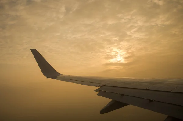 El sol está entre las nubes. Vista desde la ventana del avión . — Foto de Stock