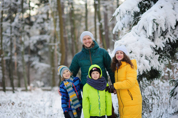 Family portrait in the winter forest.